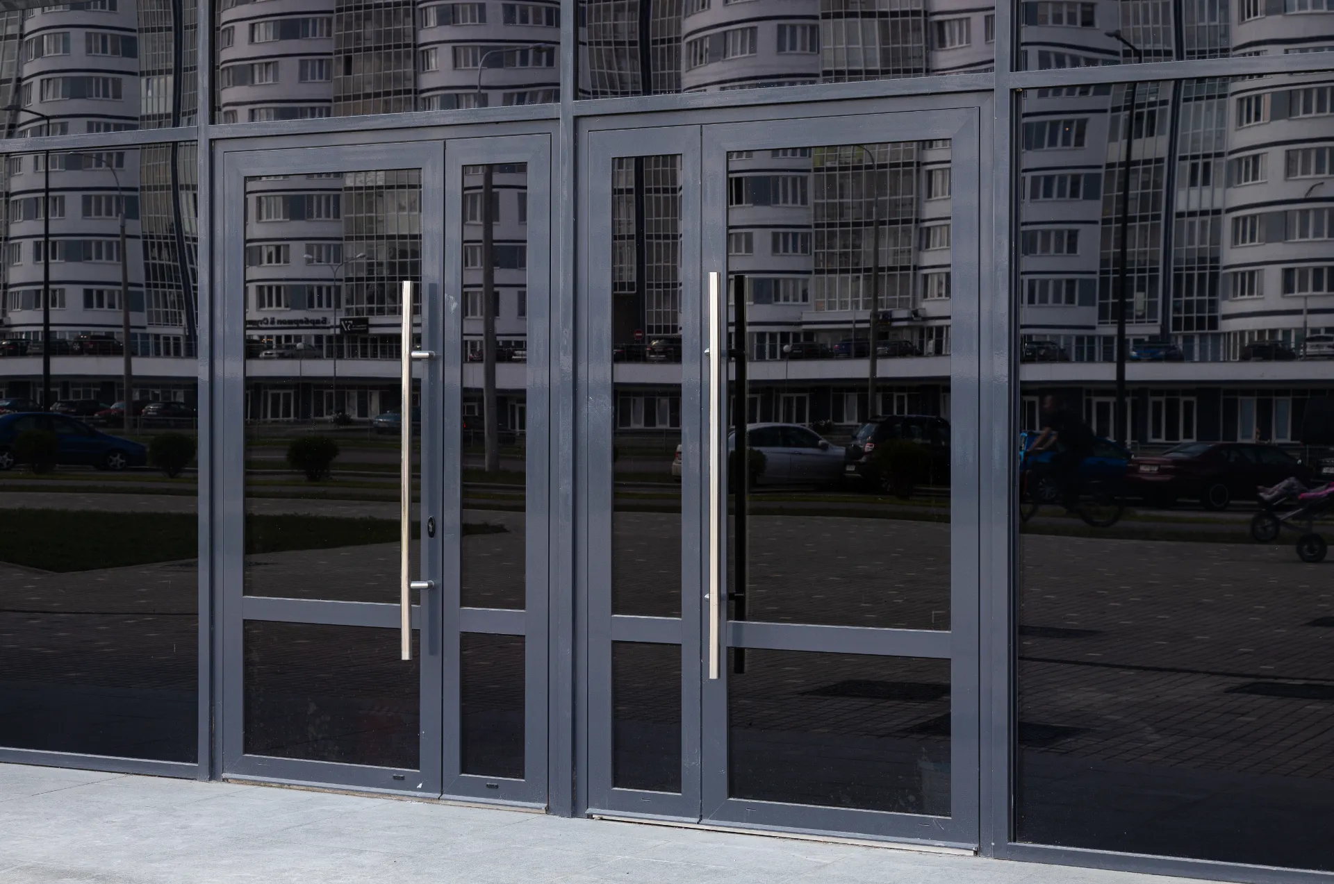 black-glass-doors-reflecting-block-of-flats-standi-2025-02-12-08-21-44-utc